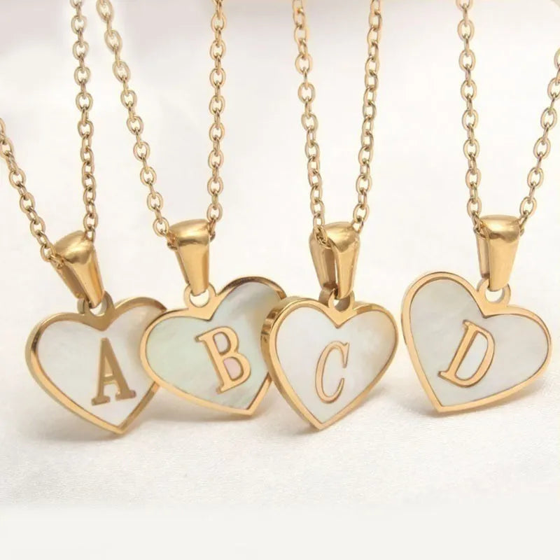 Gold plated chain necklace with a white shell heart-shaped pendant personalised with a single letter initial.