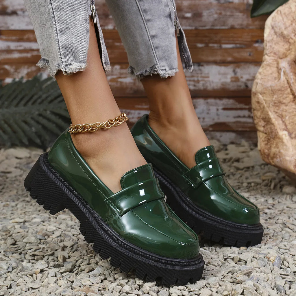 Black chunky heel loafers with a thick rubber sole and platform, shown from the side.