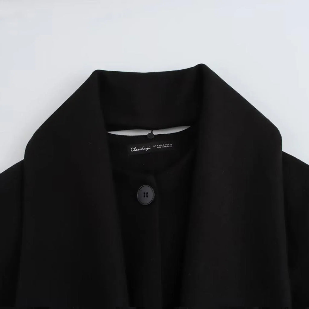Women's long black polyester overcoat with a grey artificial fur collar, shown at full length.