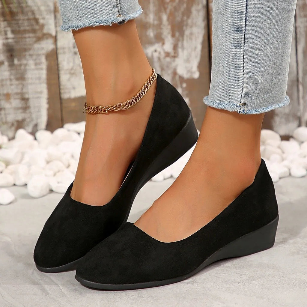 Women's pointed toe suede wedge pumps with a low heel and shallow V-cut opening in multiple colours.