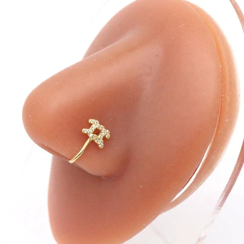 Copper geometric nose ring with electroplated K9 finish in Platinum or Gold, shown in twelve zodiac star sign styles.