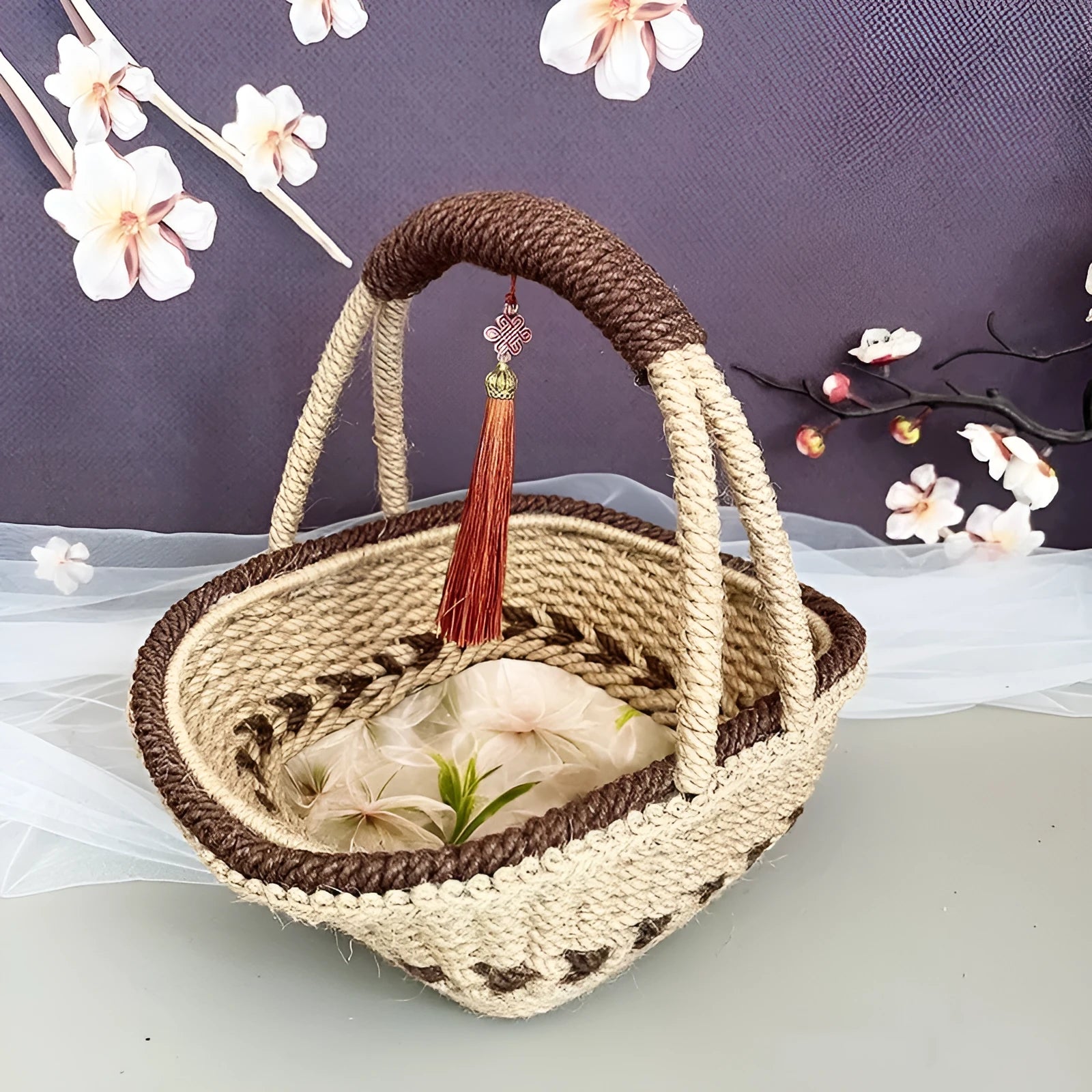 Coffee brown hand-woven straw basket with hemp rope handle, shown next to a small plant for scale.