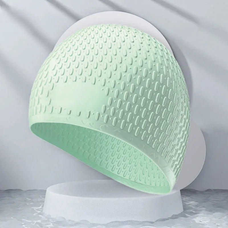 A solid colour silicone swimming cap for adults, shown in one of nine available colour options.