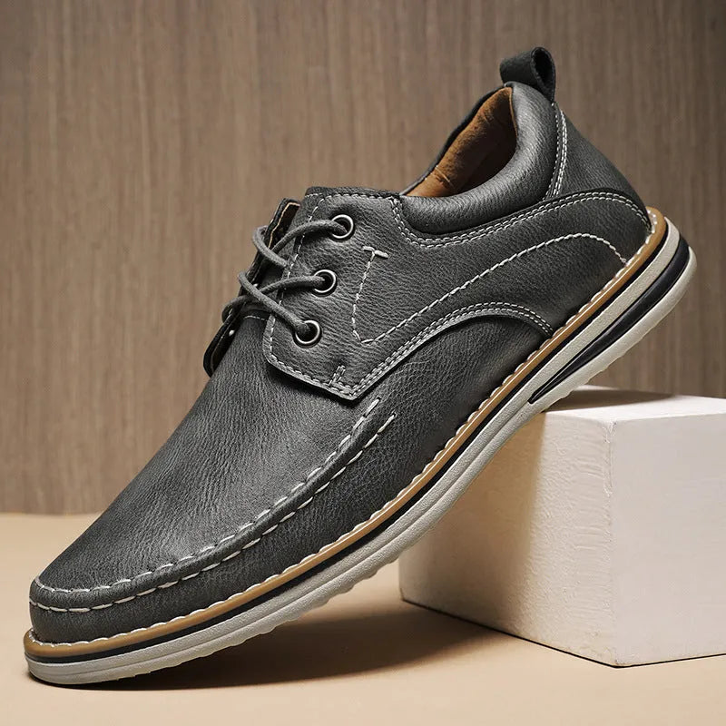 Men's genuine cowhide leather casual shoes in black with round toe and front lace-up design on a neutral background