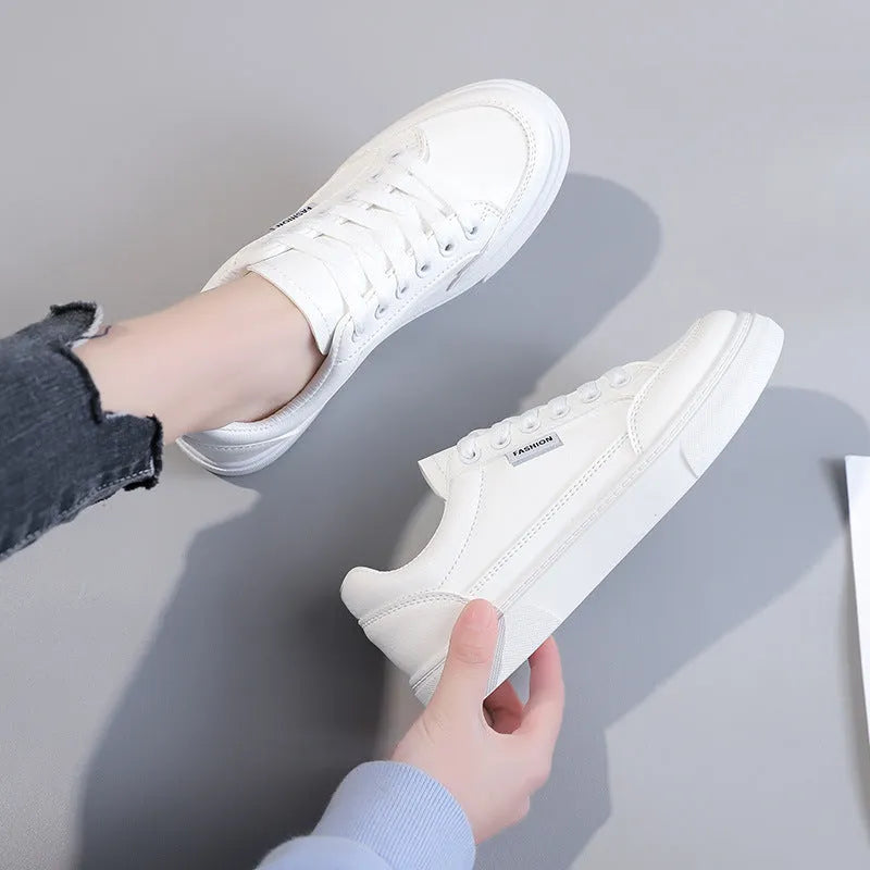 Korean style low-top sneakers in white and brown artificial PU leather with a plastic sole.