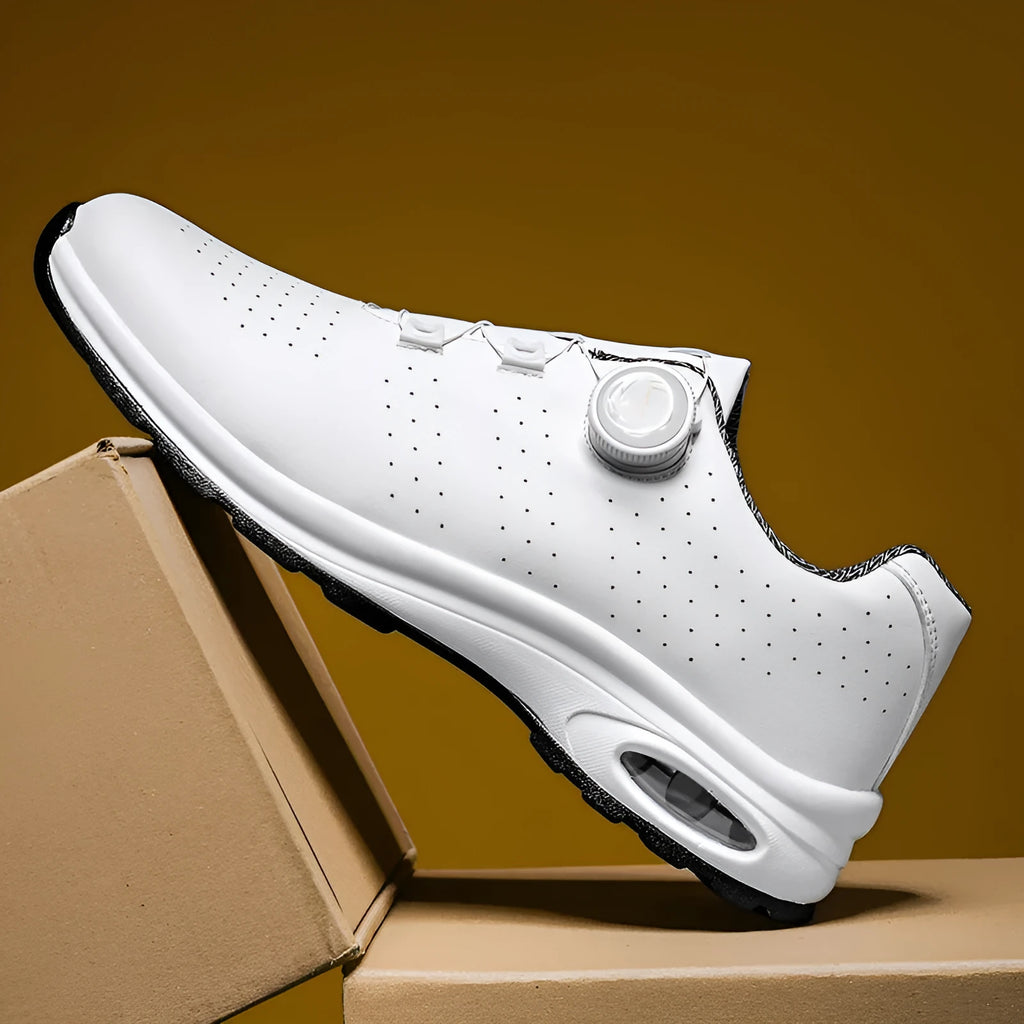 Black and white low-top mesh casual tennis shoes with cross shoulder straps and flat soles.
