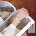 Freshwater pearl bracelet for women showing elastic and chain fastening options with fan-shaped alloy clasp