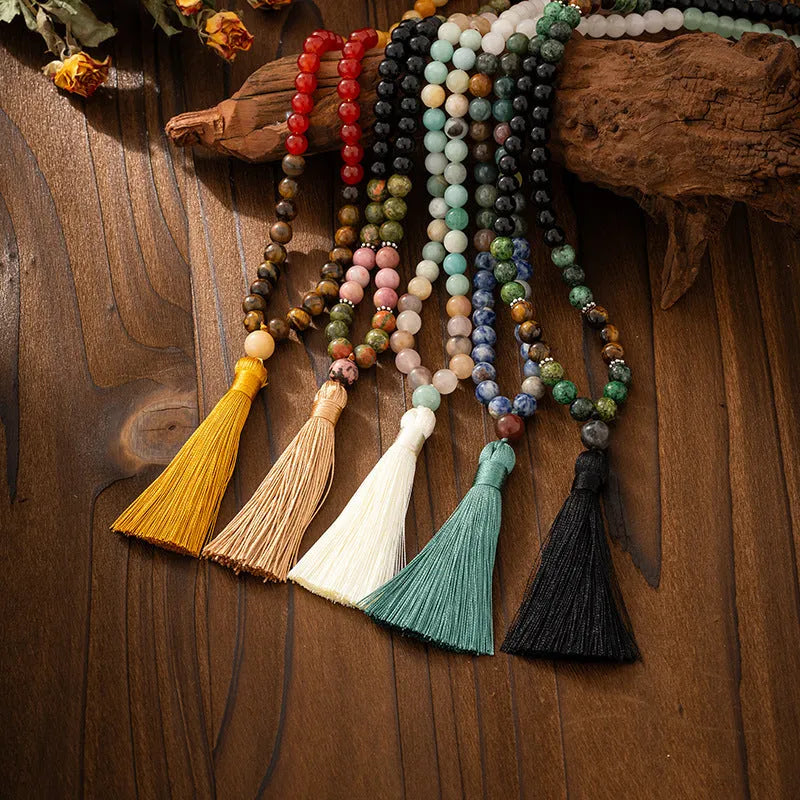 Bohemian style long necklace with natural stone beads and matching bracelet on a jumper