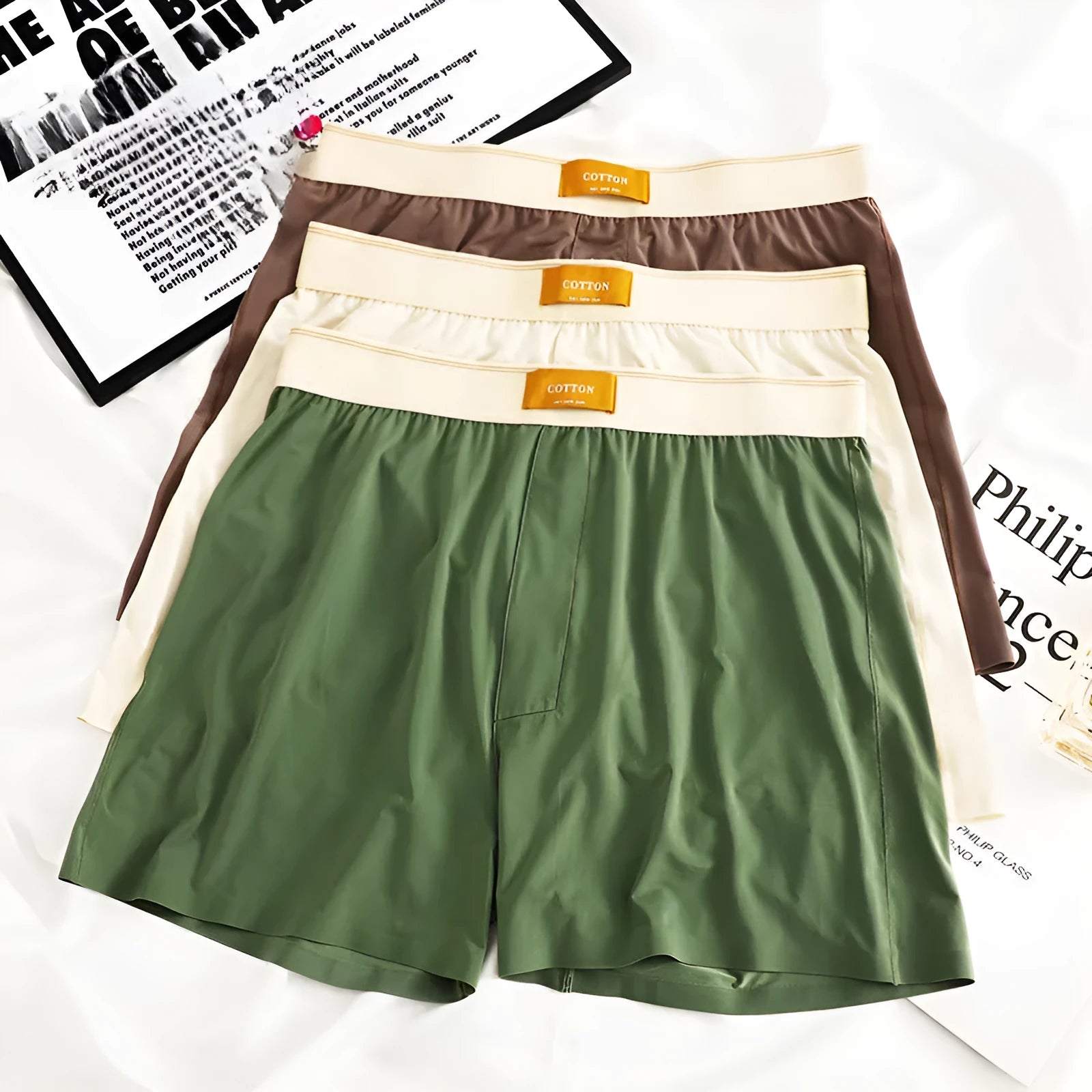 Men's solid colour loose ice silk underwear in beige apricot, laid flat.