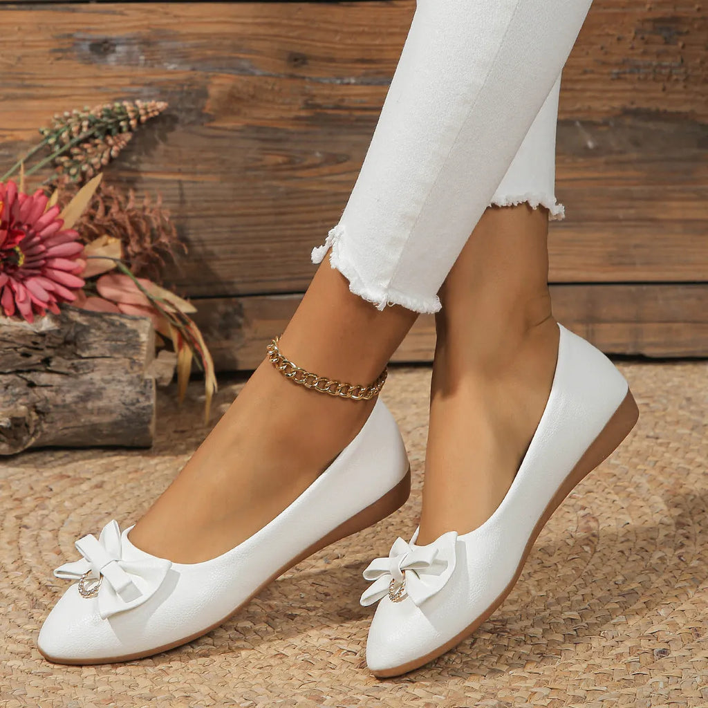 Women's beige flat casual shoes with a bowknot on the shallow mouth and a round toe.
