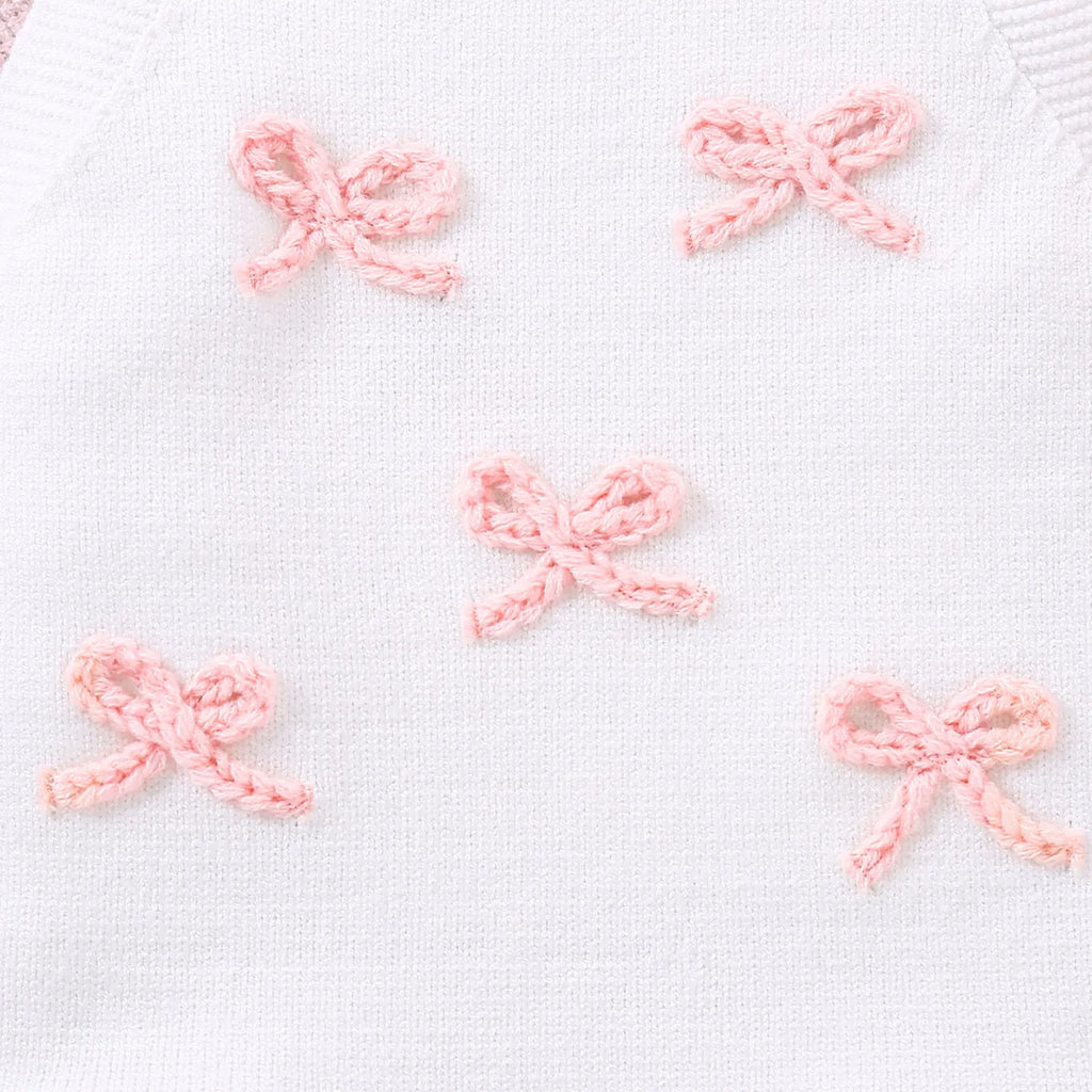 Baby sling-style wool blend romper with bow embroidery, in white or pink, sizes 0-3M to 12-18M