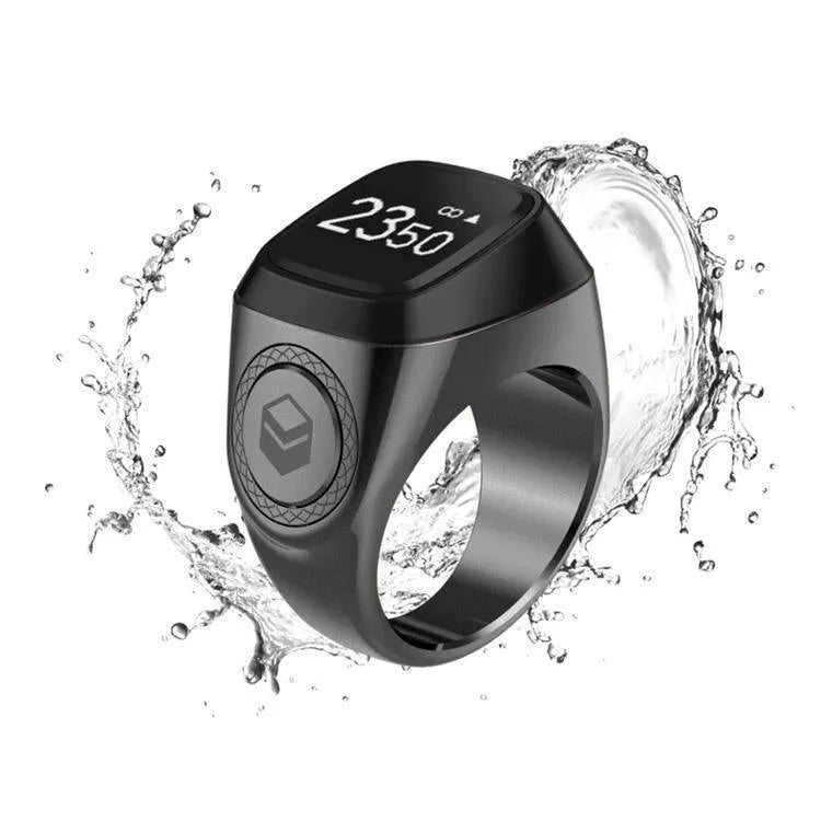 Silver smart ring with a button and small OLED display on a finger.