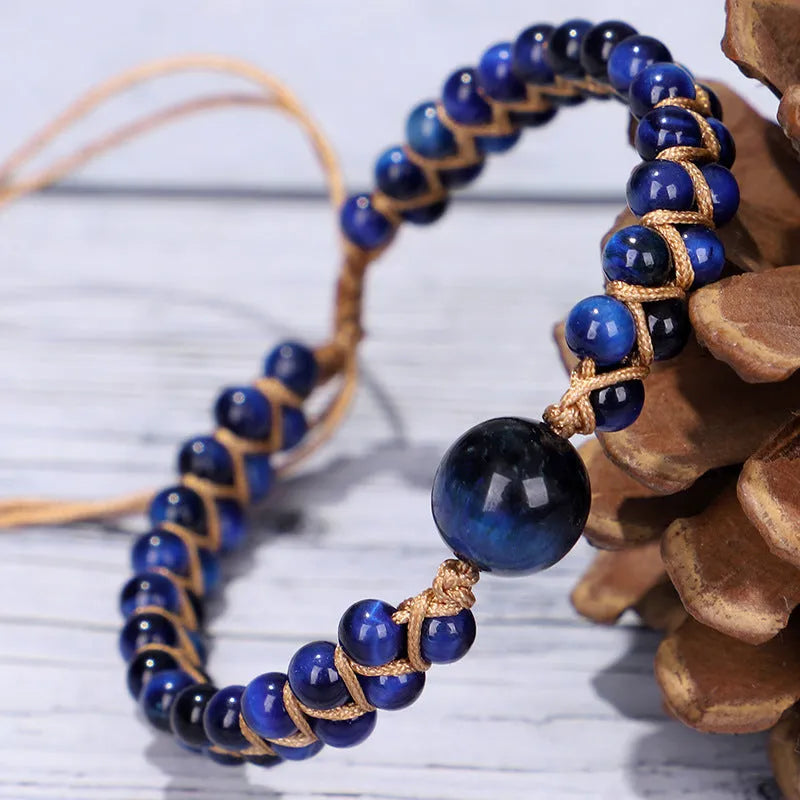 Close-up of a handmade woven bracelet with geometric tiger eye beads on an adjustable band.