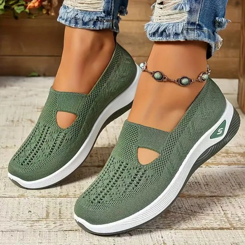 Women's low-top mesh casual flats with a T-strap in various colours on a soft PVC sole.