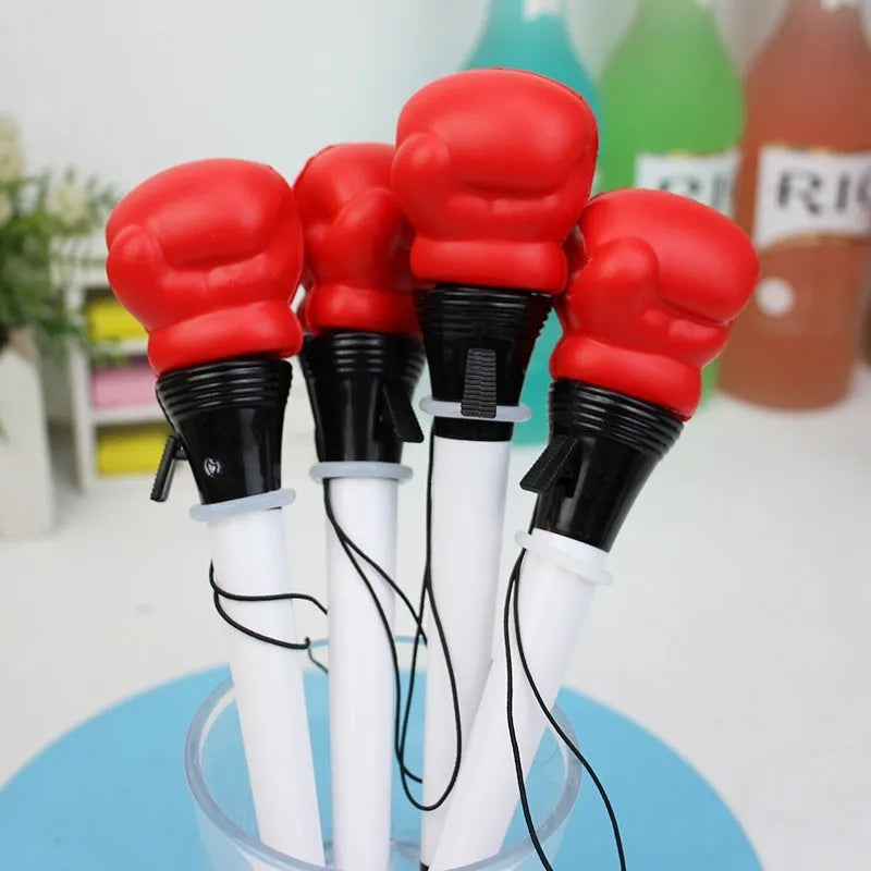 Four black boxing press ejection pens with a bullet-shaped 0.7mm tip on a desk.