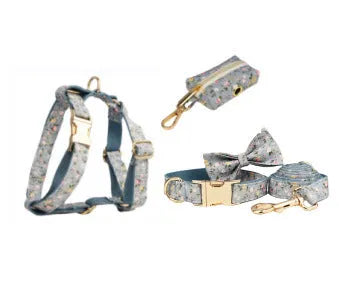 Blue floral pattern dog collar with matching leash, bow tie, vest and waste bag accessories on white background