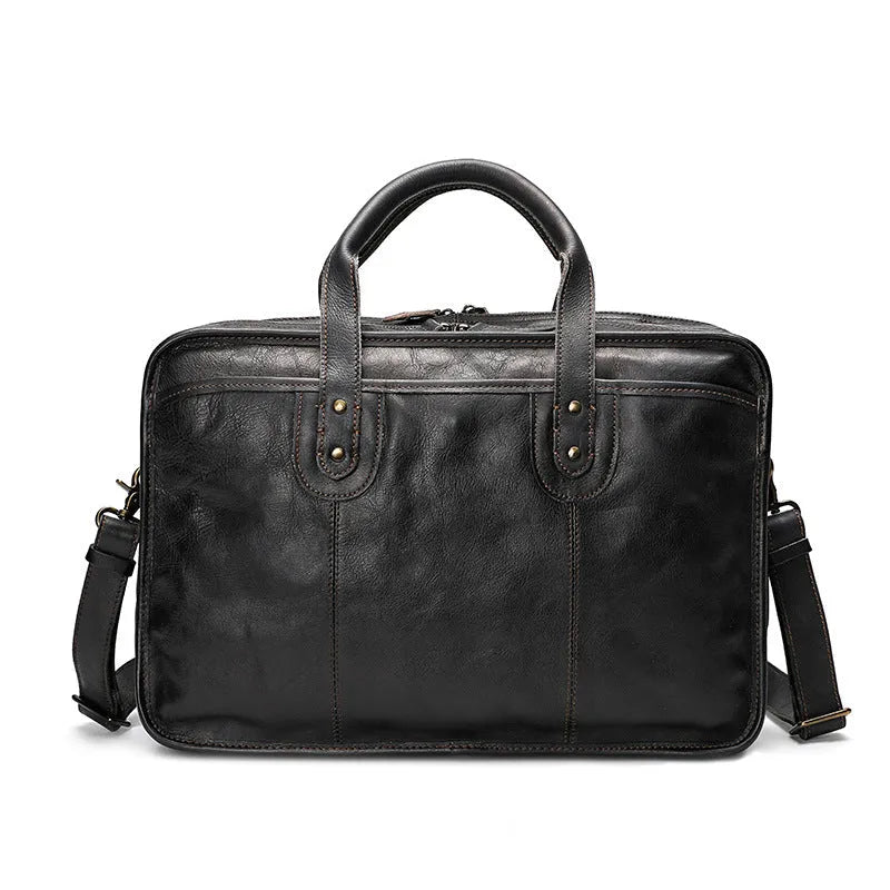 Large vintage leather men's briefcase showing internal laptop, document, camera, and phone compartments