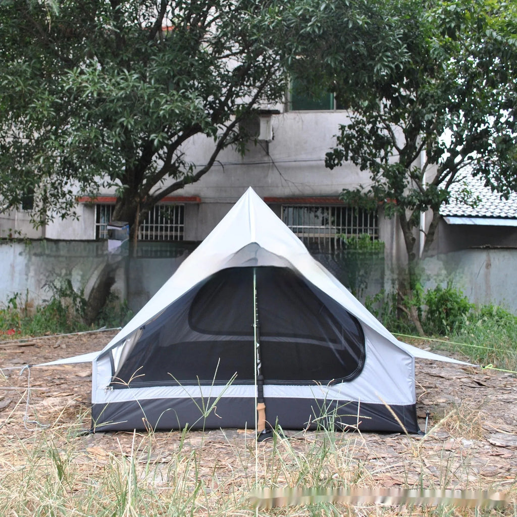 Brown A-line tent pitched with hiking poles, showing guy lines and aluminium ground nails.