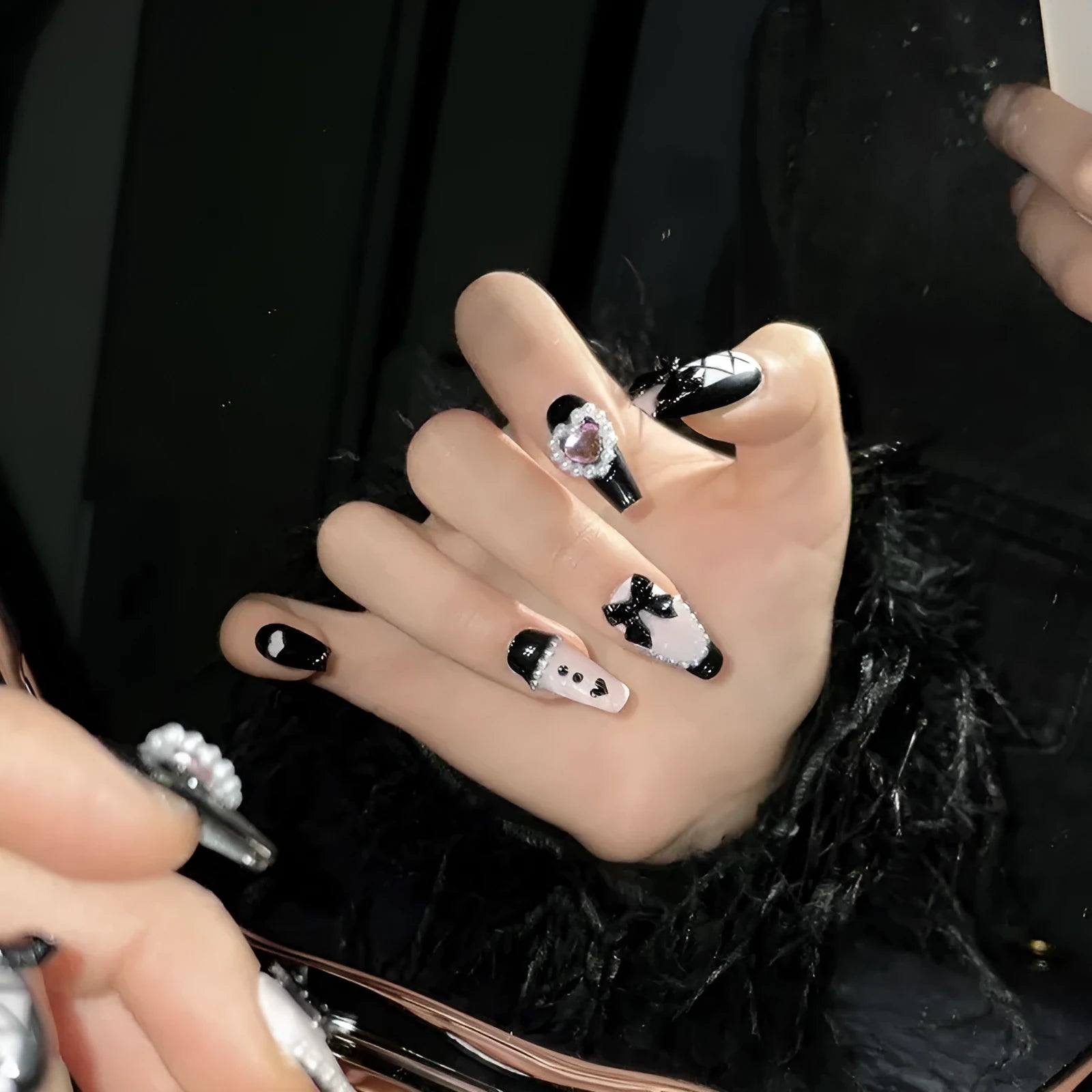Handmade black and pink heart-shaped false nails with Cat's Eye, Bow, and XINGX hand-painted designs.