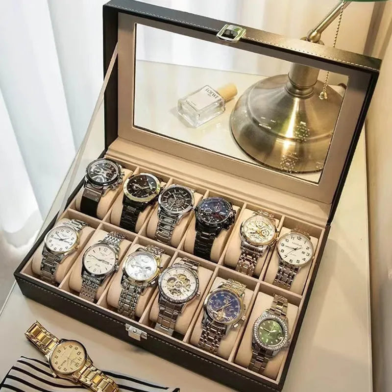 Grey leather watch storage box with clear dustproof lid showing multiple watch slots inside.