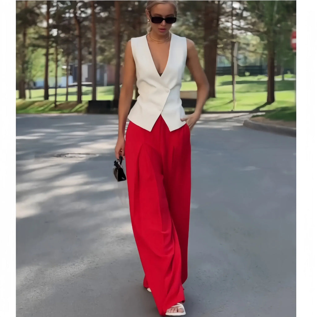 Beige women's two-piece set with sleeveless V-neck top and wide-leg trousers on a hanger.