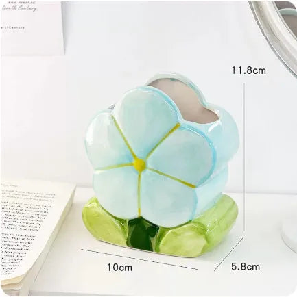 Ceramic flower pen holder storage box in floral pattern colours on desktop