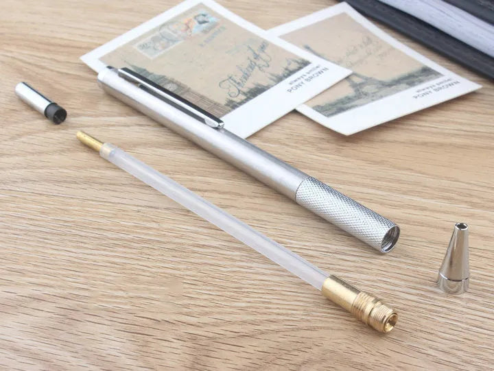 Silver metal mechanical pencil with clip, shown with compatible lead refills in sizes 0.5mm and 2.0mm.