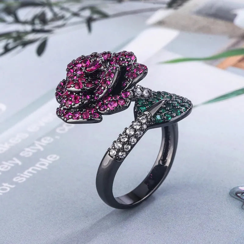 Gold-plated copper ring with geometric flower design and simulation red corundum in black gold finish