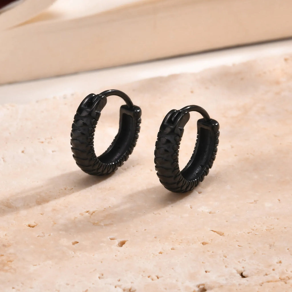 A pair of stainless steel hip hop ear rings with a snake pattern design in a black finish.