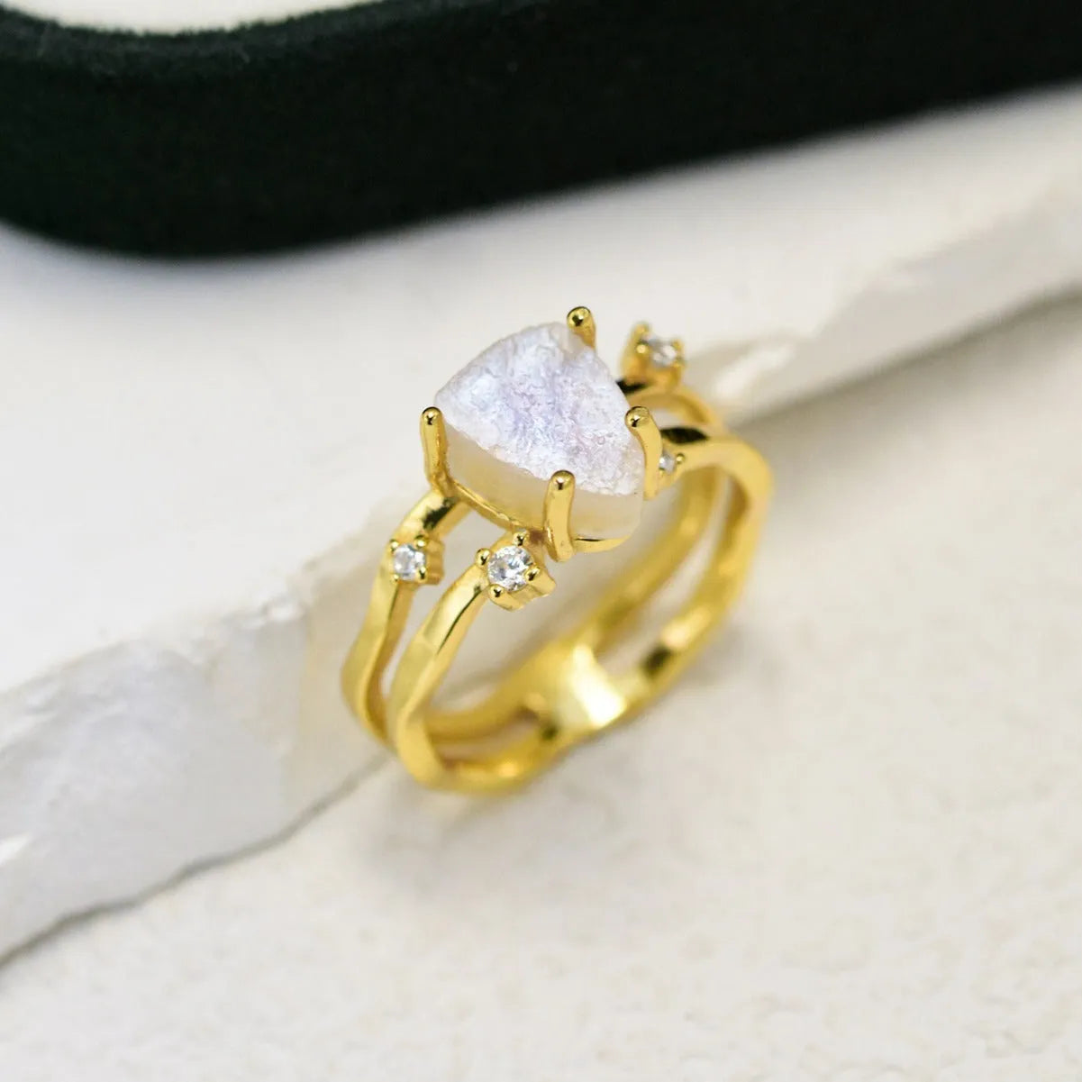 S925 silver geometric ring featuring an irregular triangle design with a moonstone, shown in rose gold, white gold, and yellow gold finishes.