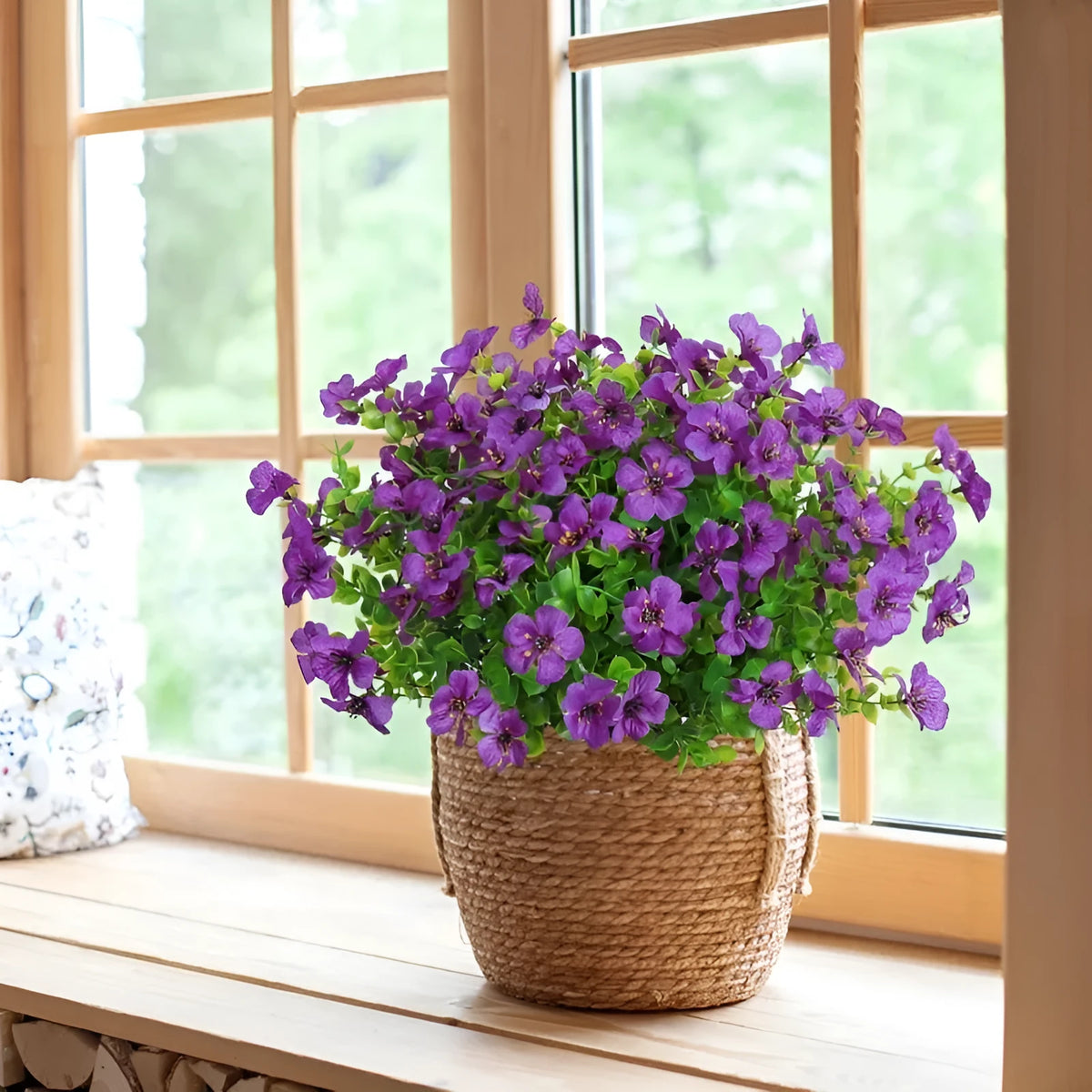 Single artificial eucalyptus flower stem in purple plastic with green leaves