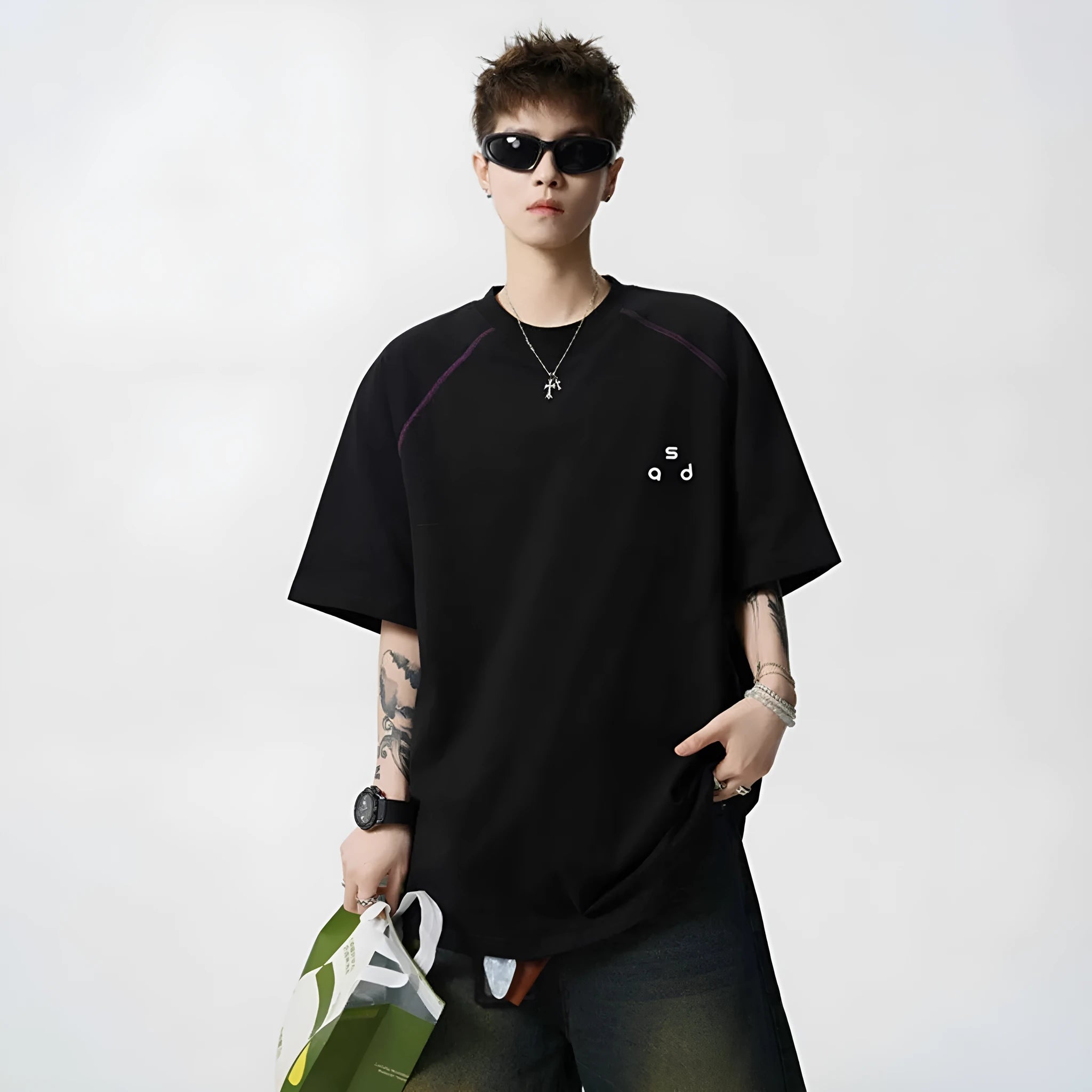 Loose fit black cotton t-shirt with letter print graphic on front, short sleeves, and round neck.