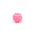 Four bright spiked squeaky dog balls in blue, green, pink, and yellow for small breed puppies.