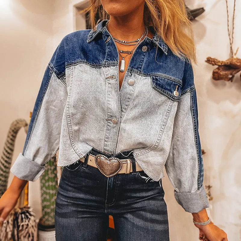 Blue women's loose fit denim coat with a single row of multiple buckles down the front.