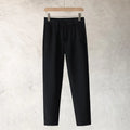 Boy wearing slim straight tapered wool trousers in grey for a business casual outfit.