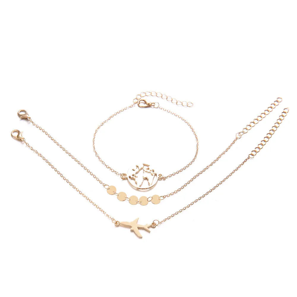 Three bohemian-style bracelets with aircraft map heart charms in electroplated alloy