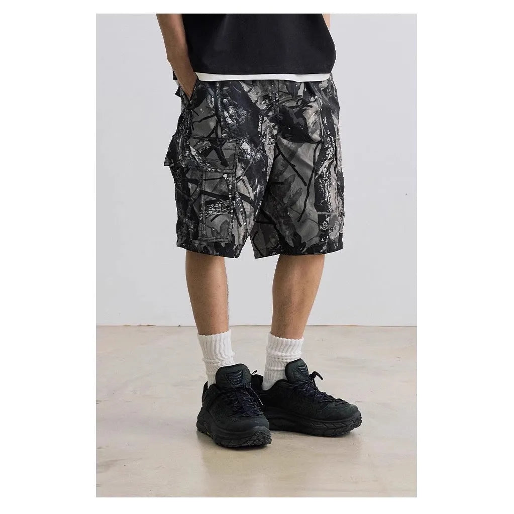 Loose fit straight-leg denim shorts in black or army green on a hanger, showing mid-waist and zip fly detail.