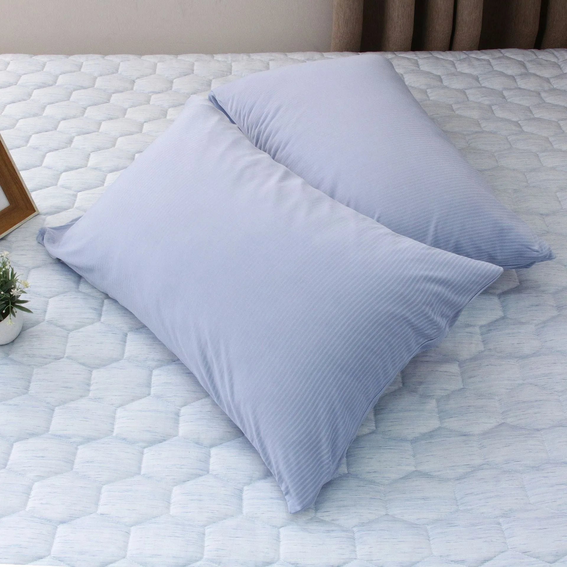 Blue and grey polyester cooling blanket with Japanese Q-Max fibres on a bed.