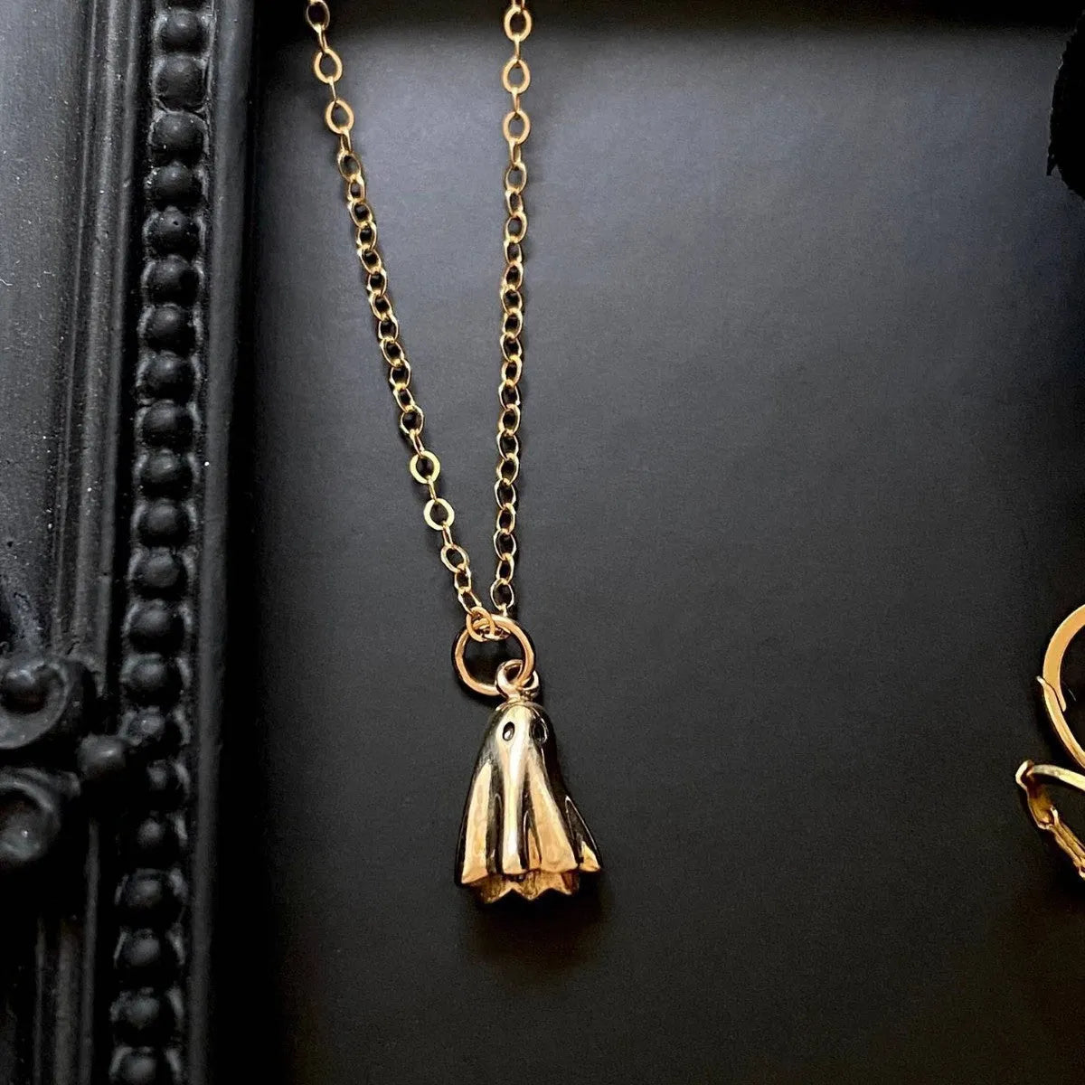 Stainless steel necklace with a detailed titanium steel ghost pendant on a twisted chain.