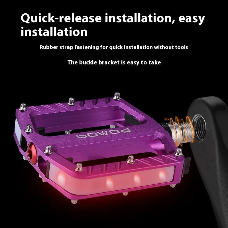 Aluminium alloy bicycle pedals with built-in LED lights in purple, black, titanium, red, and gold colour options.