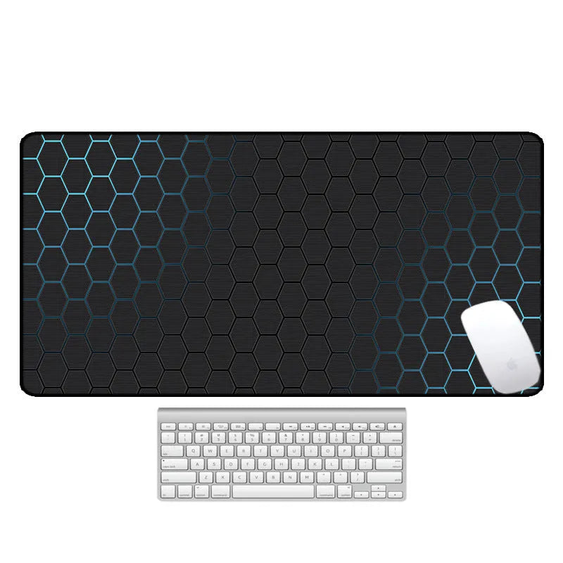 Large patterned desk mat for mouse and keyboard on a wooden desk.