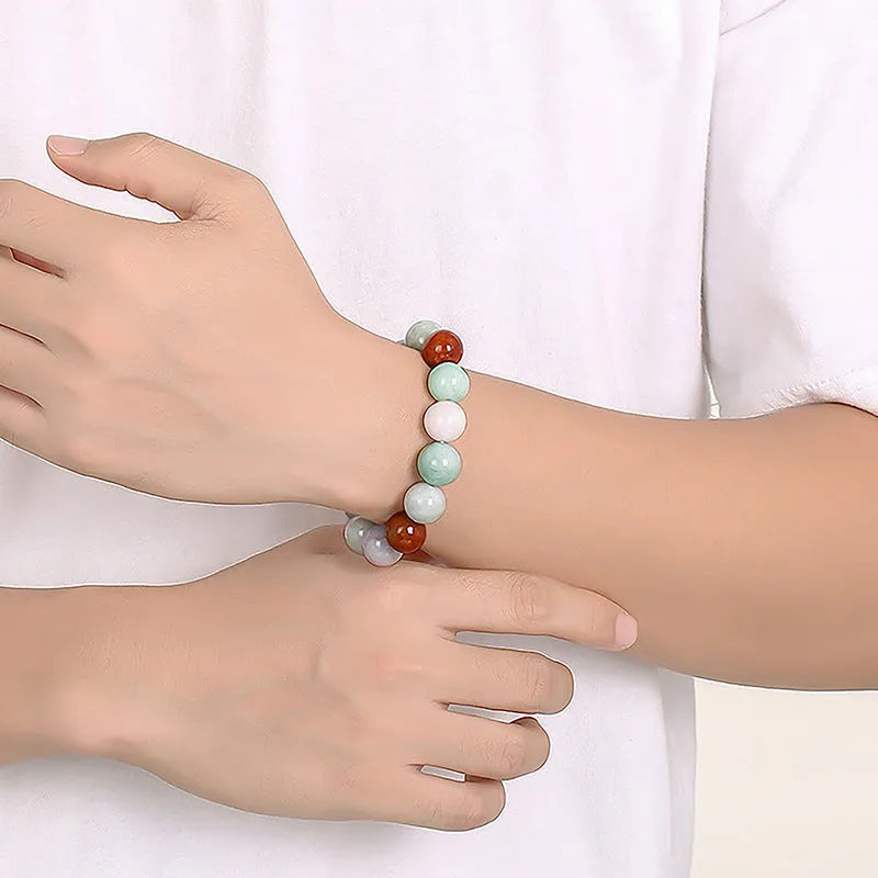 Women's jade bracelet with green, lavender and white beads showing certificate