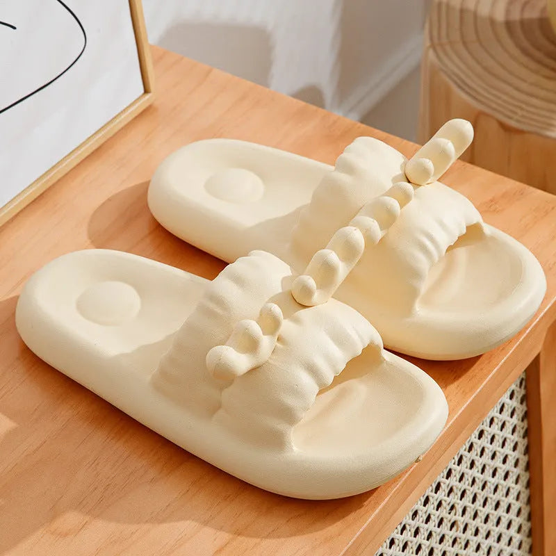 White deer horn pattern EVA flip-flop slippers with hollow-out design on a bathroom floor