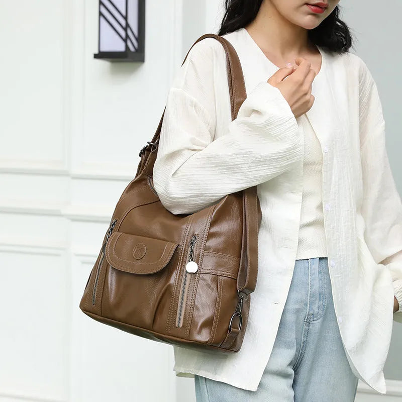 Women's PU leather shoulder messenger bag with zip compartments, available in black, brown or champagne