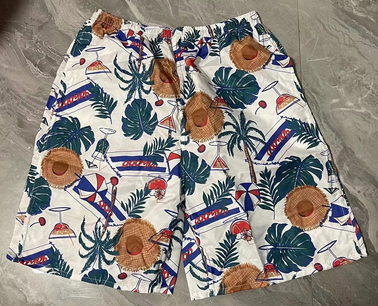 Men's floral print five-point swimming trunks in polyester fabric for pool and beach use