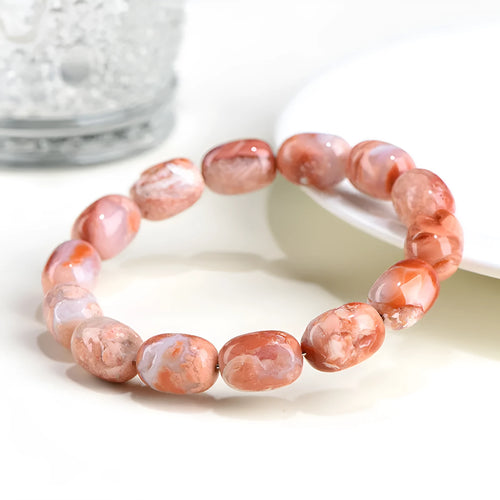 Natural cherry blossom coloured agate barrel bead bracelet with a Ruyi charm.