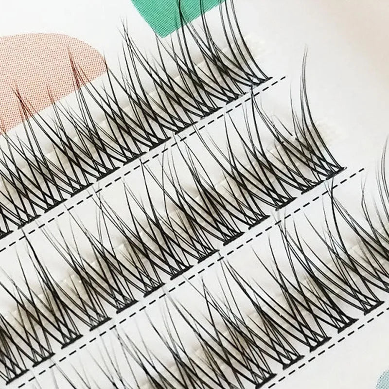 Black v-shaped fairy fishtail false eyelashes with thick segments on a white background.