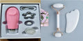 White jade double-headed facial roller and gua sha board set on a flat surface.