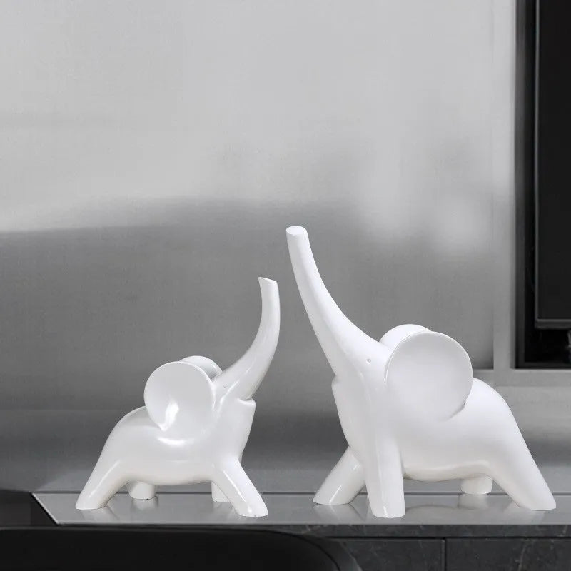 Modern resin and plastic elephant ornament in rose gold or white colour, available in large, small, or pair sizes.