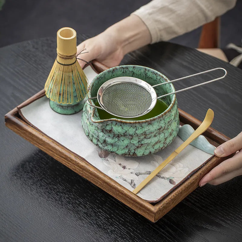 Seven-piece Japanese style matcha set with ceramic bowl, bamboo whisk, stand, tea tray, filter screen, and tea towel in gift box